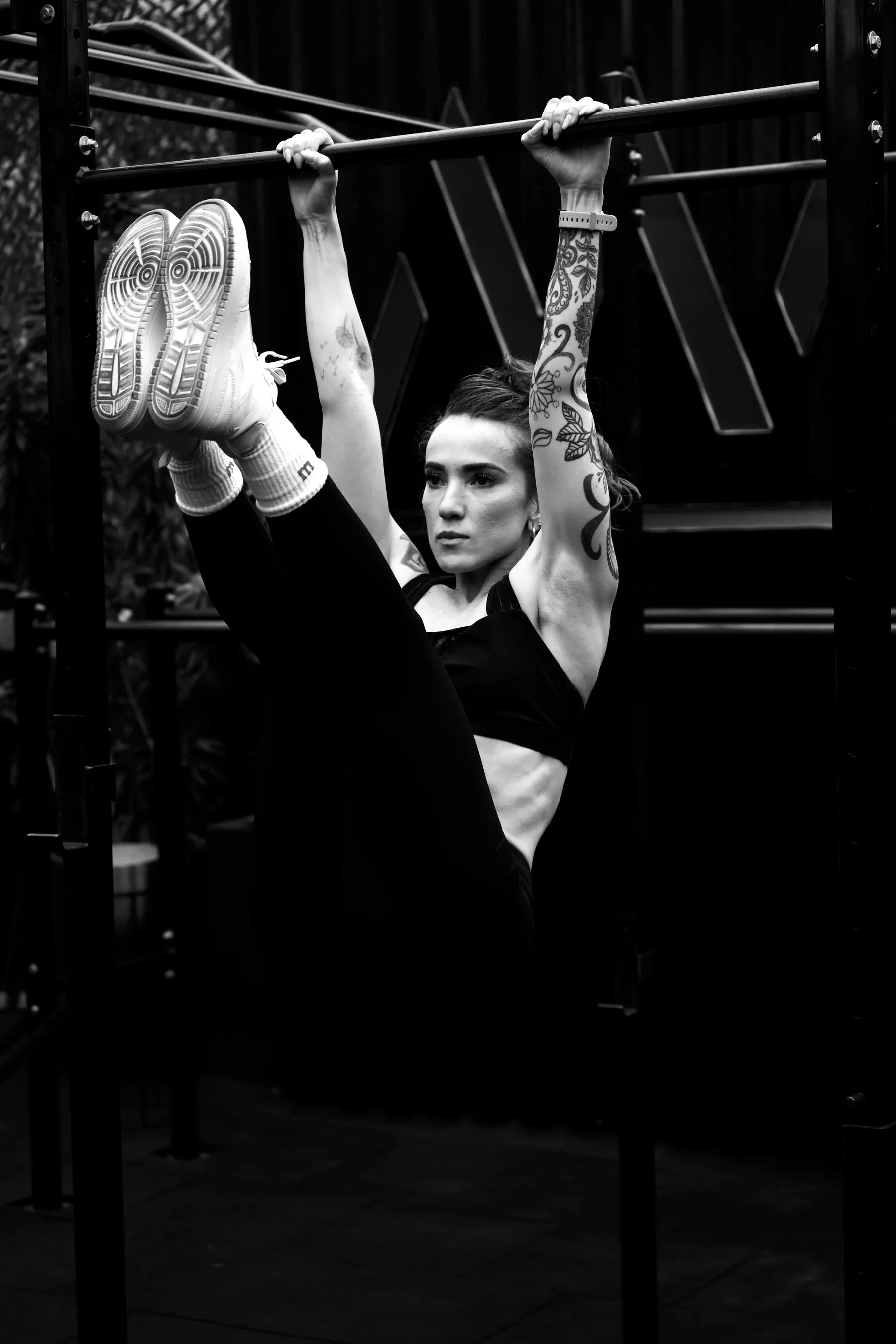 A woman pressing a weight overhead, black and white