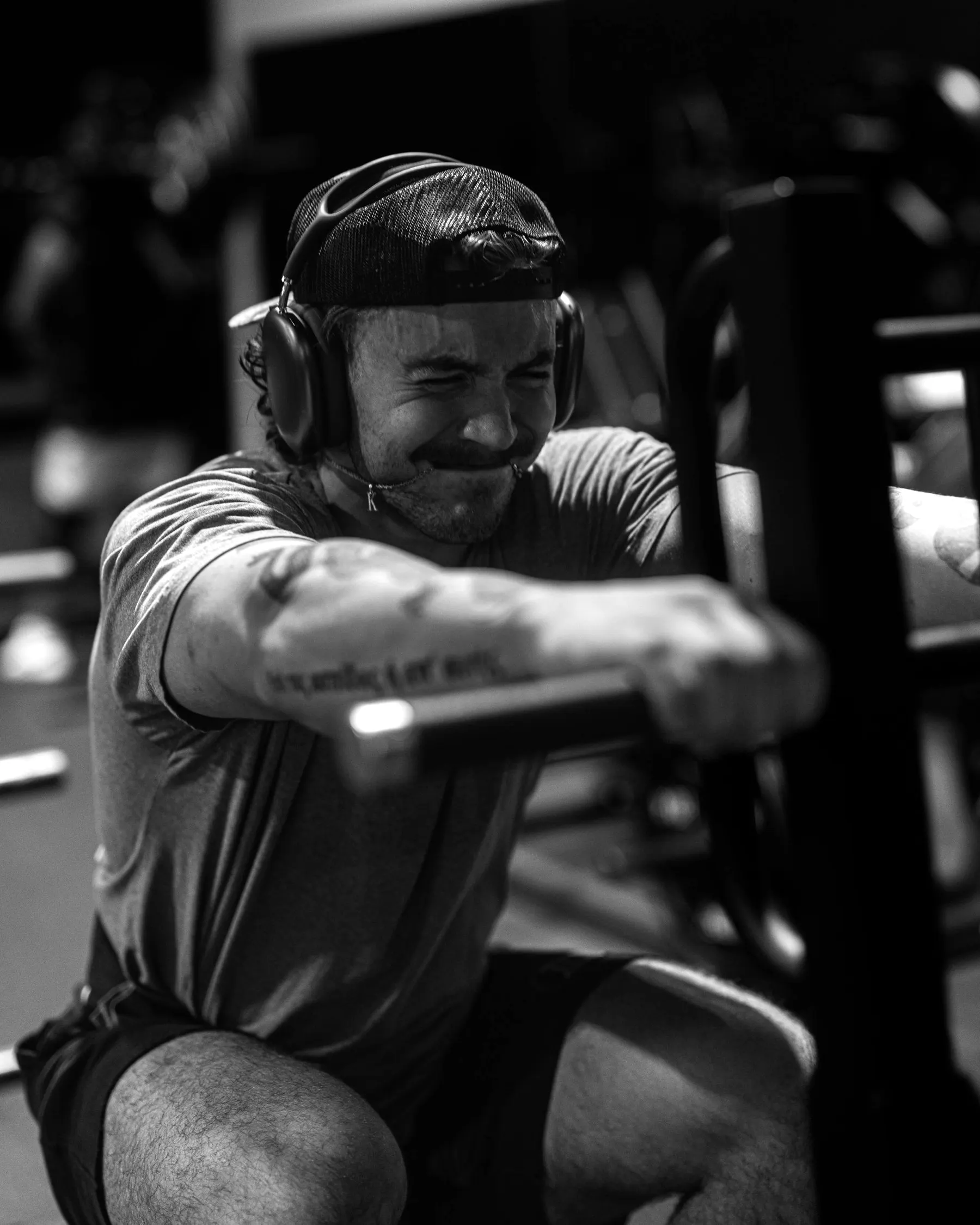 A man training hard on a rowing machine, black and white